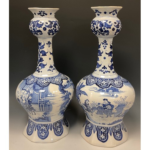 339 - A pair of large Dutch delft baluster vases, of Chinese garlic head design, painted in tones of blue ... 