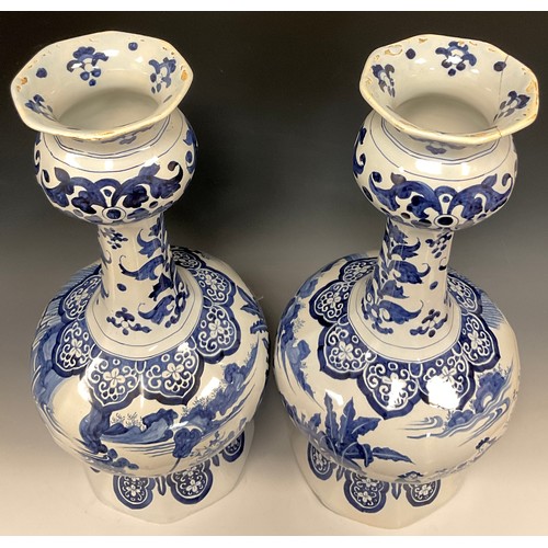 339 - A pair of large Dutch delft baluster vases, of Chinese garlic head design, painted in tones of blue ... 