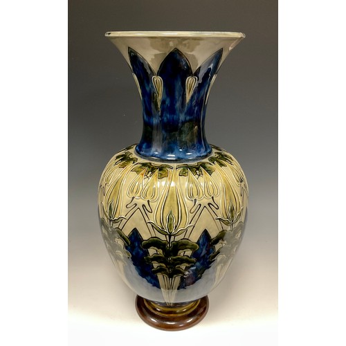 311 - A Royal Doulton stoneware vase, incised and relief moulded with Art Nouveau floral leafy motifs in g... 