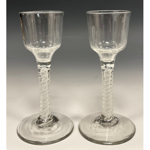 393 - A pair of George III opaque twist drinking glasses, ogee bucket shaped bowls, double-helix cotton st... 