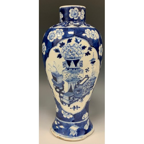 401 - A Chinese baluster vase, painted in tones of underglaze blue with precious objects, within lotus res... 