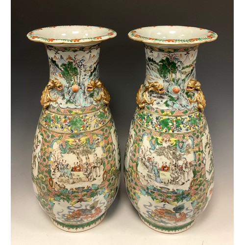 423 - A pair of 19th century Chinese Canton famille Rose vases, decorated with traditional figure panels, ... 