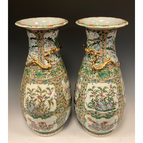 423 - A pair of 19th century Chinese Canton famille Rose vases, decorated with traditional figure panels, ... 