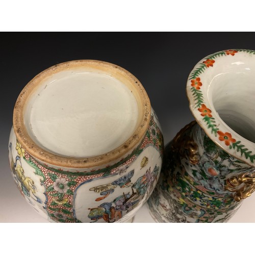 423 - A pair of 19th century Chinese Canton famille Rose vases, decorated with traditional figure panels, ... 