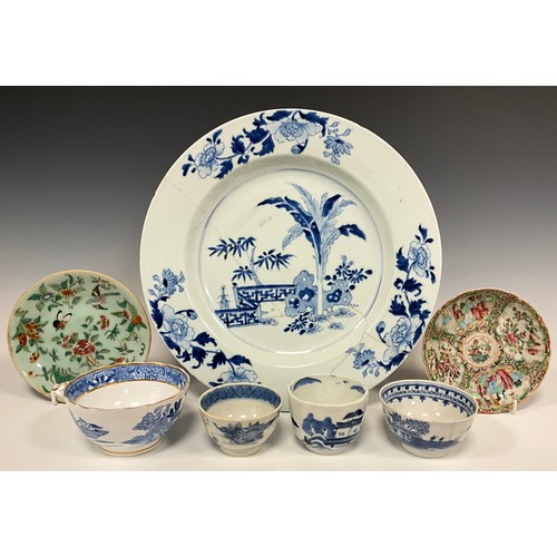 409 - A Chinese under glazed blue tea bowl, painted with traditional scenes of figures, buildings and rive... 