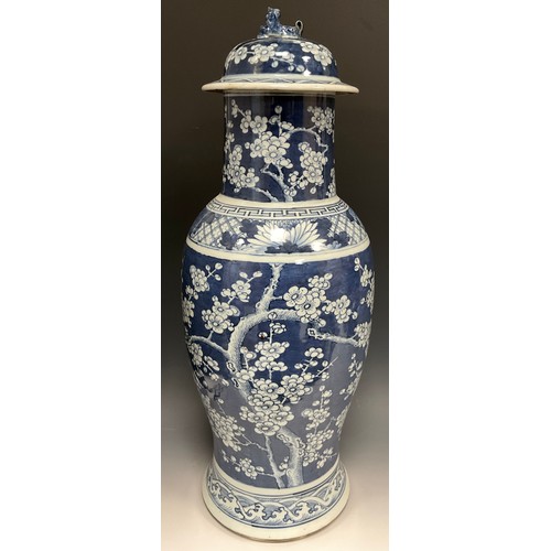 420 - A large Chinese baluster vase and cover, painted in tones of underglaze blue with blossoming prunus ... 