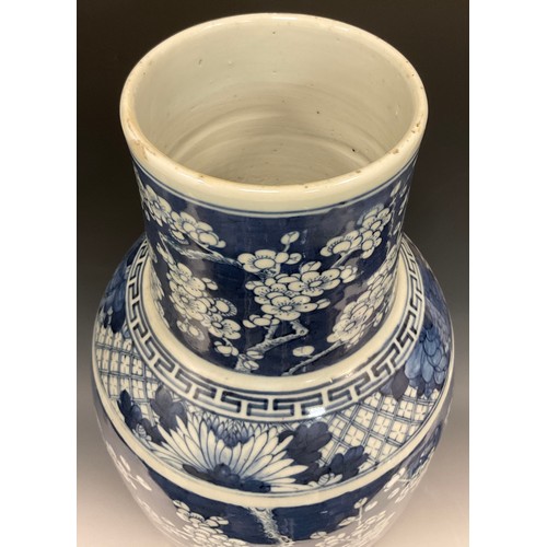 420 - A large Chinese baluster vase and cover, painted in tones of underglaze blue with blossoming prunus ... 