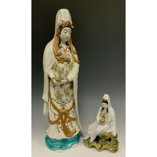 418 - A Japanese Shōwa period Kutani figure of Kannon (Guanyin), 49.5cm high;  another similar smaller sea... 