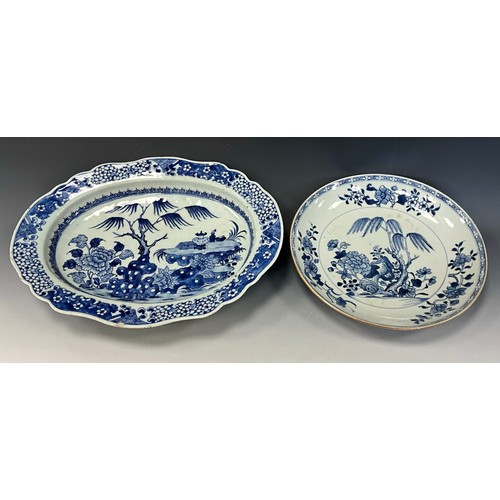 432 - An 18th century Chinese blue and white serving dish of shaped oval form, the deep bowl decorated wit... 