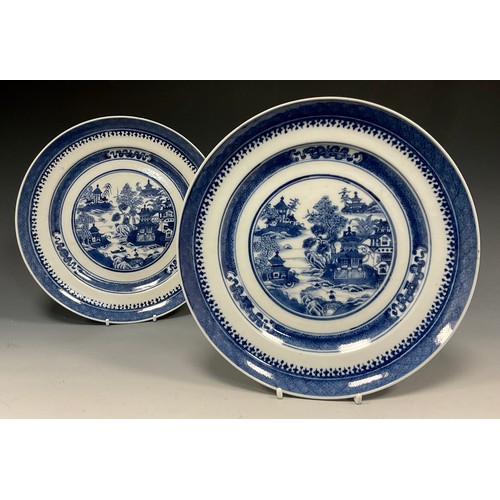 428 - A pair of Chinese under glazed blue and white plates, well painted traditional landscape with River ... 