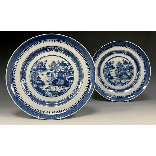 428 - A pair of Chinese under glazed blue and white plates, well painted traditional landscape with River ... 