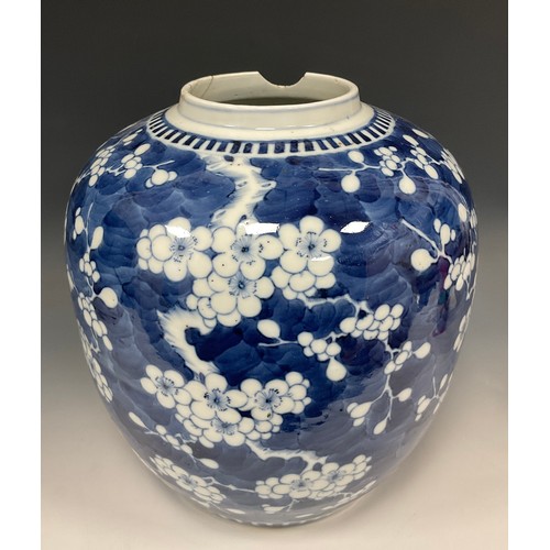 421 - A large Chinese ginger jar, painted in tones of underglaze blue with blossoming prunus on a ground o... 