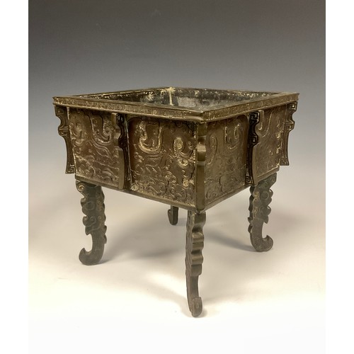 435 - A 19th century Chinese Archaic style bronze censer of square form, relief decorated with cresting wa... 