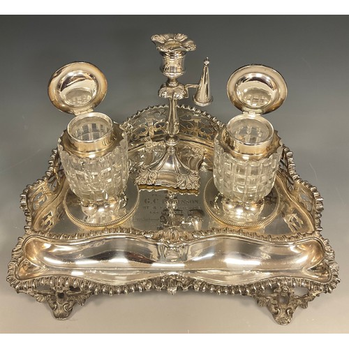 133 - A Victorian Elkington & Co inkstand, the rounded triangular base with pierced gallery back, two lidd... 