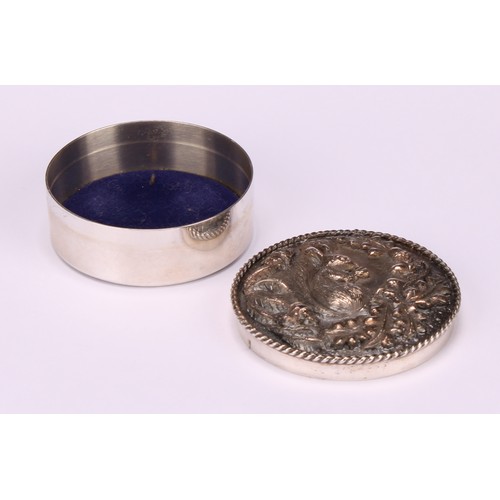 101 - An Elizabeth II silver circular trinket box, the push-fitting cover in relief with a squirrel, enclo... 