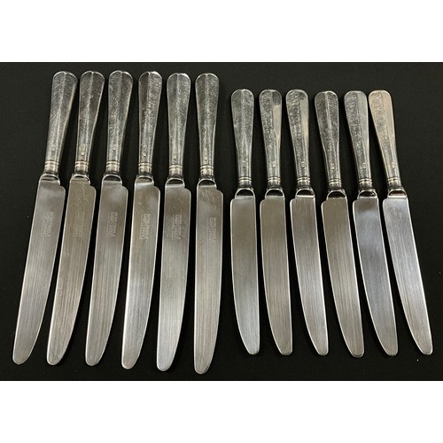 78 - A set of six silver hafted table knives and six conforming dessert knives, United Cutlers of Sheffie... 