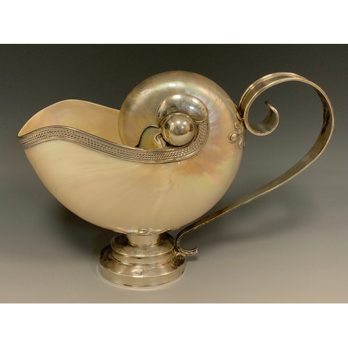 83 - A silver mounted pearl nautilus shell ewer, in the Baroque Wunderkammer taste, 25cm long