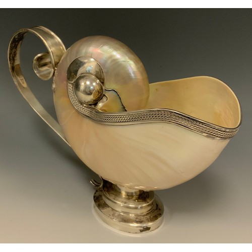 83 - A silver mounted pearl nautilus shell ewer, in the Baroque Wunderkammer taste, 25cm long