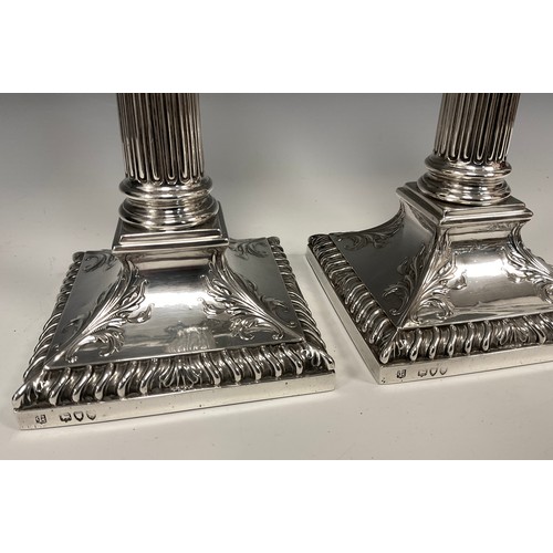 62 - A pair of Victorian silver Corinthian column candlesticks, Lambert & Co, London 1893, removable scon... 