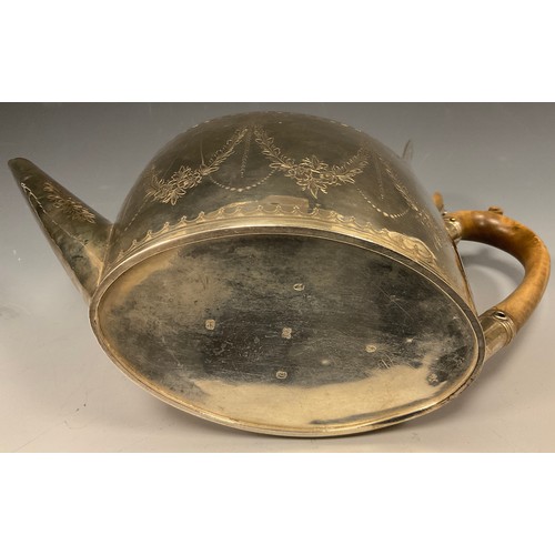 18 - A George III silver teapot, oval body with floral swags and leafy motifs, wooden handle and finial, ... 