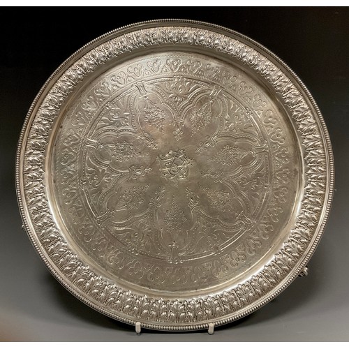 84 - A Victorian circular silver salver, heavily cast and embossed with multiple floral bands and fruit b... 