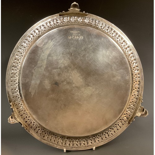 84 - A Victorian circular silver salver, heavily cast and embossed with multiple floral bands and fruit b... 