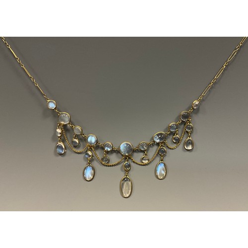 284 - An Edwardian moonstone fringe necklace, with twenty five oval and round individually mounted cabocho... 