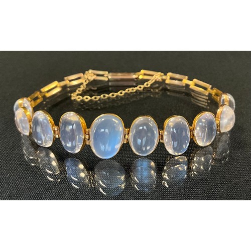 276 - An early 20th century graduate moonstone bracelet, with ten oval cabochon moonstones, unmarked yello... 