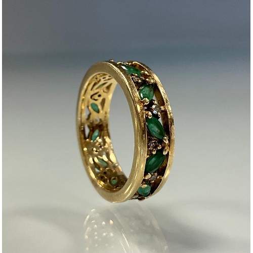 288 - An emerald and diamond eternity ring, pieced channel alternate set with eleven navette emeralds and ... 