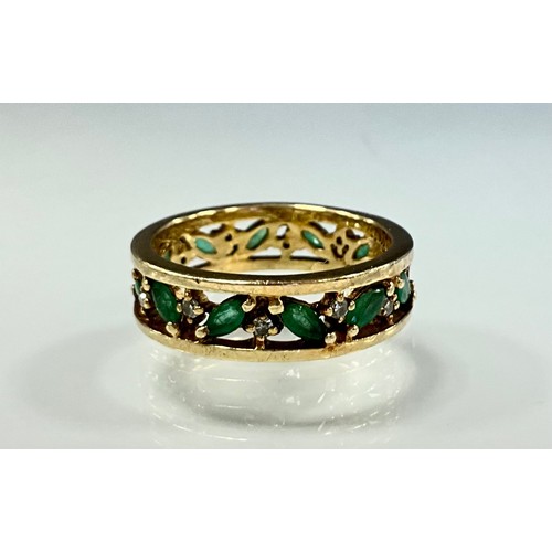 288 - An emerald and diamond eternity ring, pieced channel alternate set with eleven navette emeralds and ... 