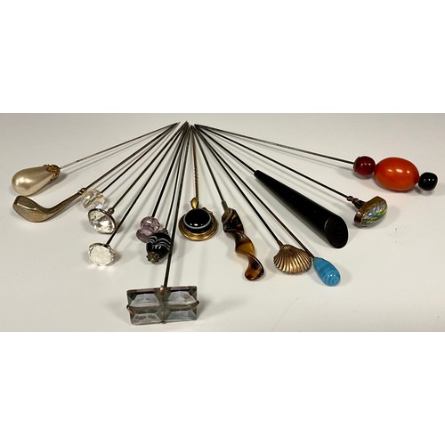 174 - A collection of fifteen Victorian and later hat pins, including silver Golf Club, Chester 1908, 9ct ... 