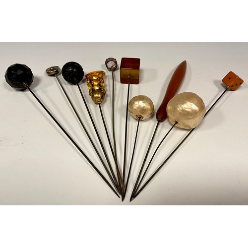 179 - A collection of ten Victorian and later hat, scarf and stick pins, including pale pink faceted round... 