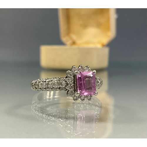 236 - A pink sapphire and diamond ring, central cushion cut rectangular sapphire appro 0.80ct, above round... 