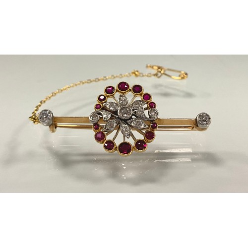 189 - A diamond and ruby floral spray pendant, set with thirteen round brilliant and old cut diamonds and ... 