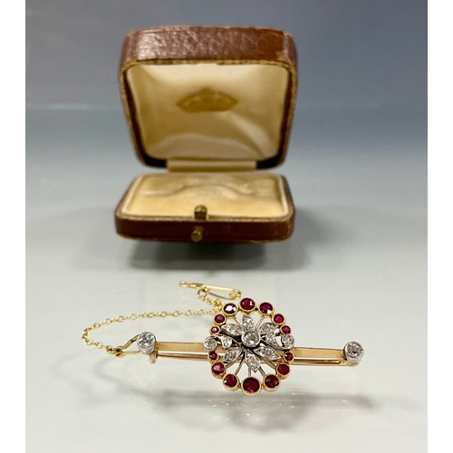 189 - A diamond and ruby floral spray pendant, set with thirteen round brilliant and old cut diamonds and ... 