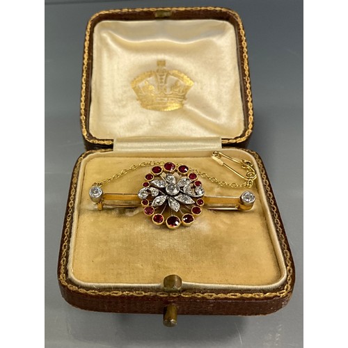 189 - A diamond and ruby floral spray pendant, set with thirteen round brilliant and old cut diamonds and ... 