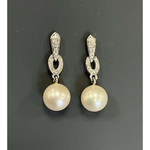 225 - A pair of Art Deco style ring and bar drop diamond and culture pearl earrings, each set with eightee... 