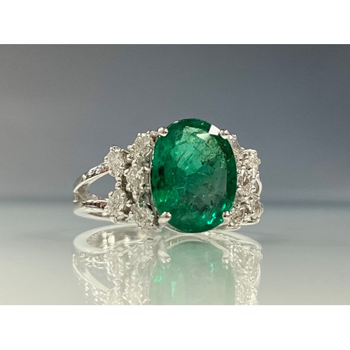 292 - An emerald and diamond ring, central oval emerald approx 2.52ct, flanked by five marquise cut diamon... 