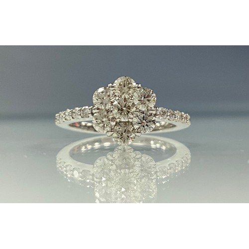 197 - A diamond cluster ring, daisy head of seven round brilliant cut diamonds, above smaller diamond acce... 