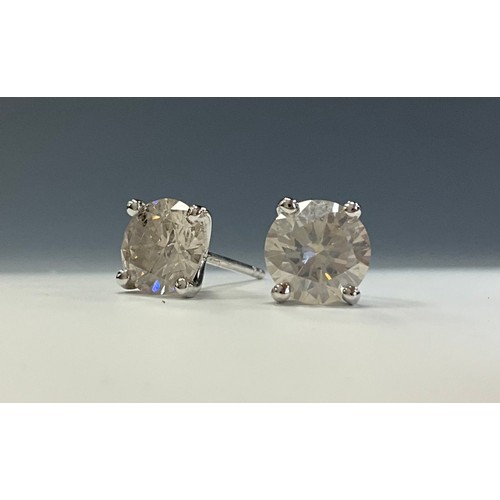 229 - A pair of diamond stud earrings, round brilliant cut four claw set diamonds, total estimated diamond... 