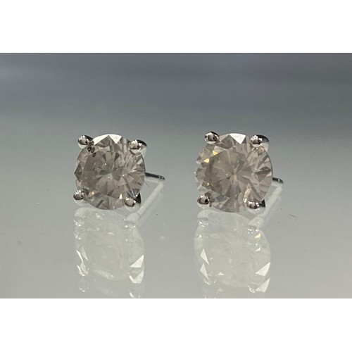 229 - A pair of diamond stud earrings, round brilliant cut four claw set diamonds, total estimated diamond... 