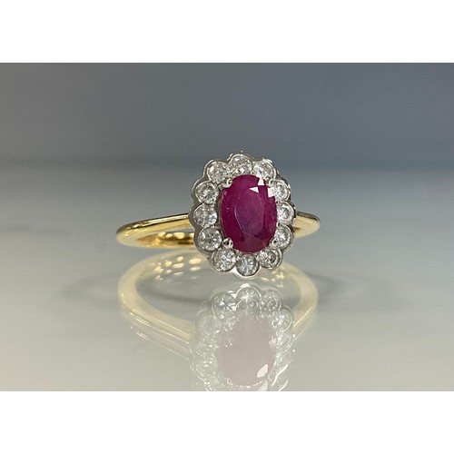 242 - A ruby and diamond cluster ring, oval pinky red ruby approx 1.02ct, surrounded by twelve round brill... 