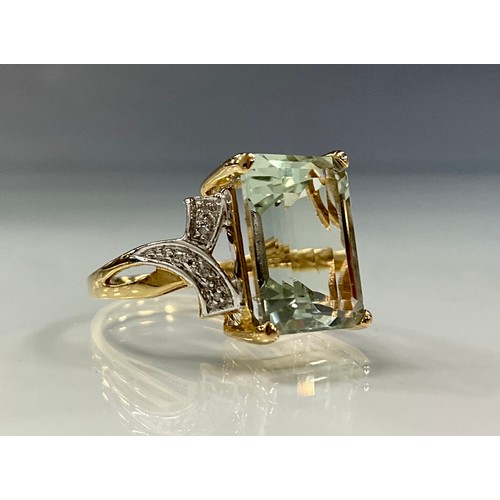 187 - A diamond and green amethyst ring, central baguette cut green blue amethyst, above ribbon cross five... 