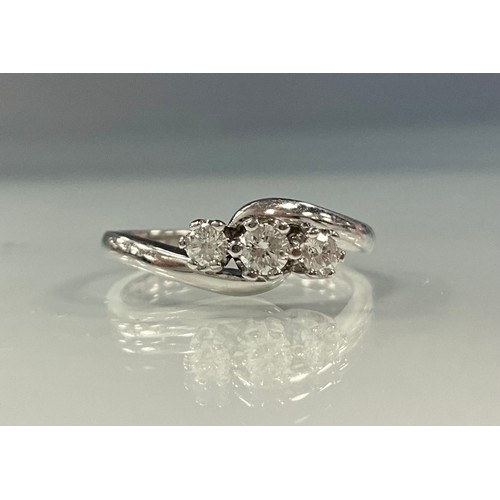 205 - A diamond twist ring, linear set with three round brilliant cut diamonds, total estimated diamond we... 