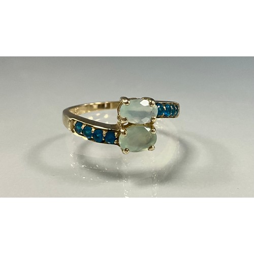 238 - A prehnite and apatite dress ring, set with two oval cut prehnites and eight round cut neon apatite'... 