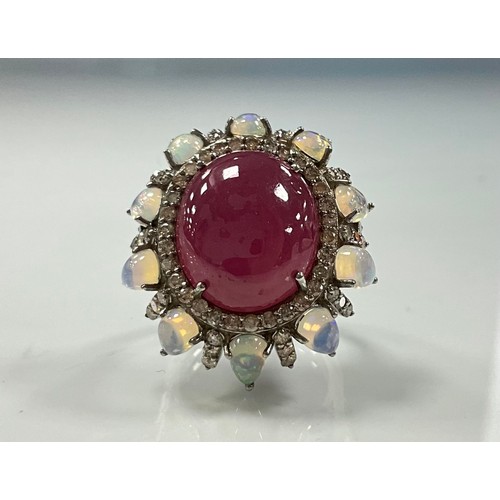 218 - A large oval ruby opal and diamond cluster ring, central cabochon ruby 21.64ct, surrounded by altern... 