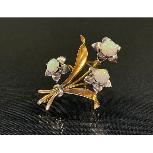 221 - A opal floral spray brooch, set with three cabochon opals, with green, blue, violet sand red play, y... 