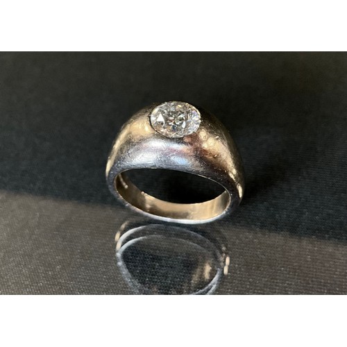 204 - A diamond solitaire signet ring, round brilliant cut diamond approx 1.35ct, rub over set to a taperi... 