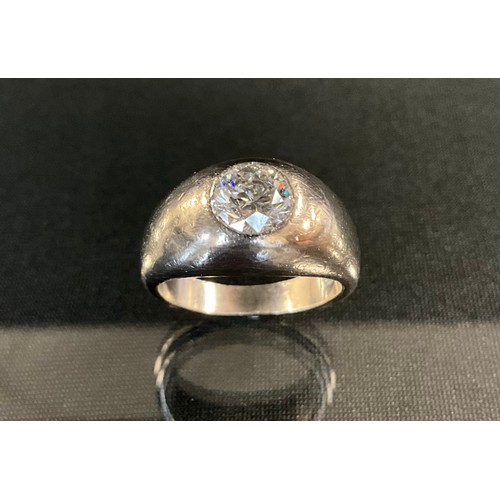 204 - A diamond solitaire signet ring, round brilliant cut diamond approx 1.35ct, rub over set to a taperi... 