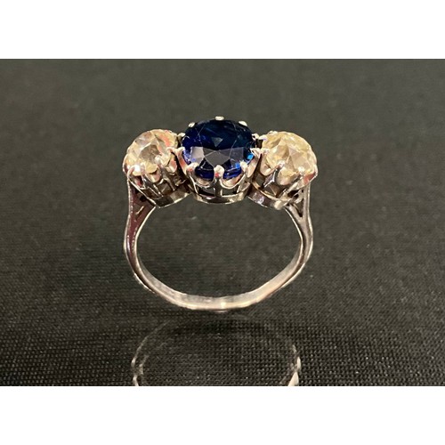 249 - A sapphire and diamond ring, central oval mid blue sapphire approx 2.13ct, between old cushion cut d... 